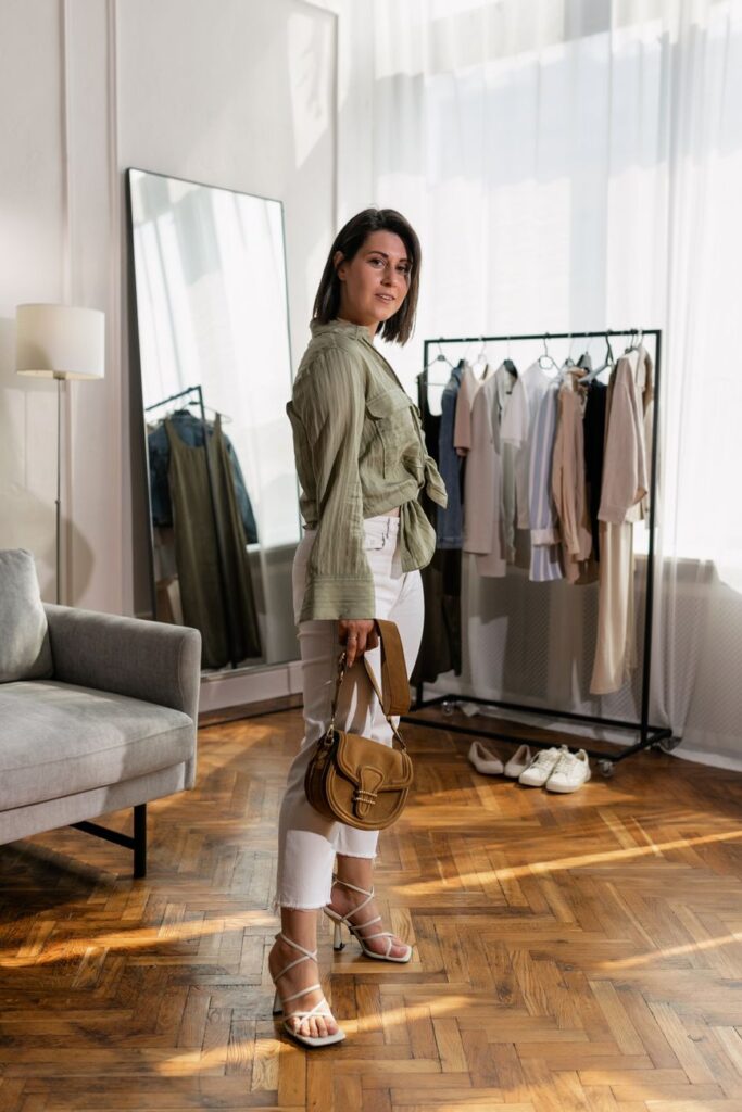 a woman in a stylish outfit standing indoors